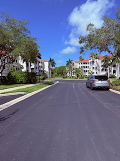 The property is situated in a quiet residential neighborhood with tree-lined streets and Spanish-style architecture, offering a peaceful setting for your vacation stay.