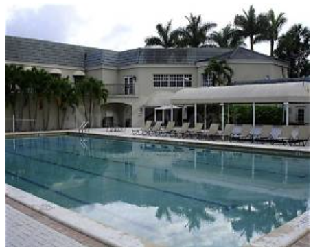 The pool area awaits beneath swaying palms, with sunbeds ready for your afternoon relaxation. Surrounded by tropical landscaping and a covered terrace, it's your personal retreat for soaking up the Florida sunshine.