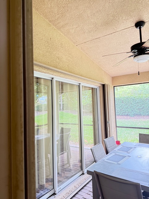 Enjoy your morning coffee in this bright sunroom, where large windows frame peaceful garden views and gentle breezes flow through.