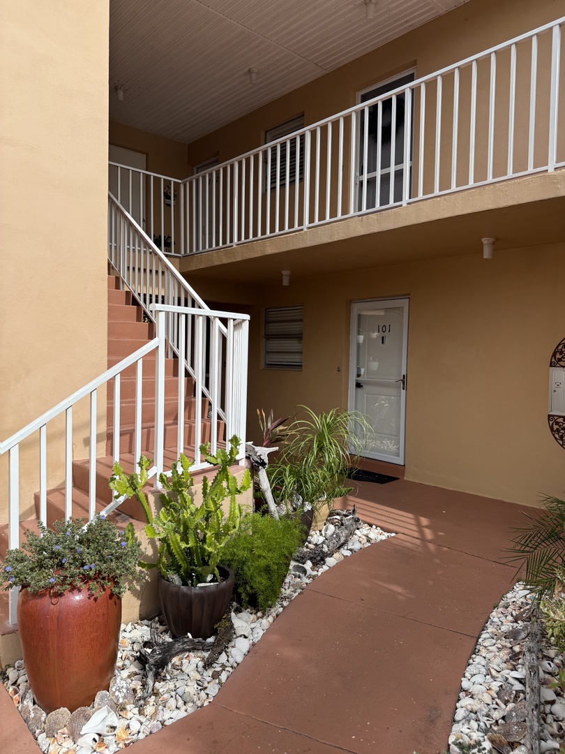 Step onto your private terrace where lush plants and stone details create a peaceful outdoor retreat.