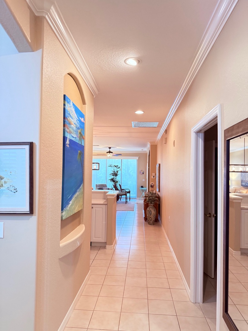 Unwind in your spacious soaking tub with natural light streaming through the skylight overhead. The generous vanity and coastal artwork add to your peaceful retreat.