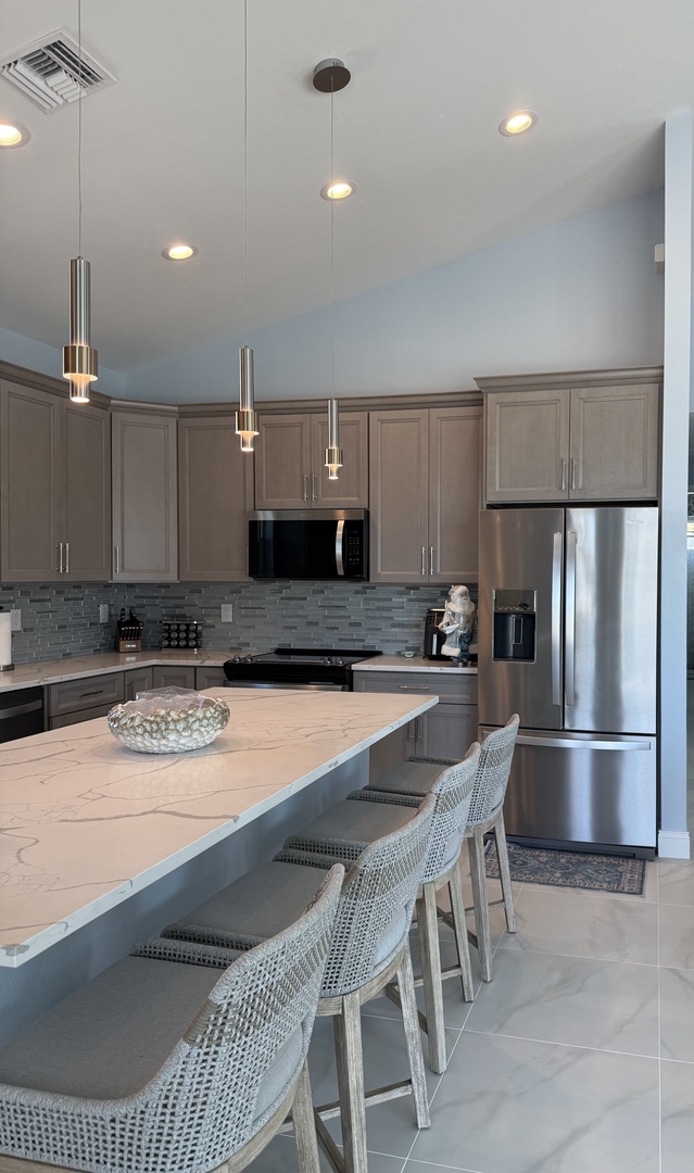 Your sleek modern kitchen features granite counters, stainless appliances, and a breakfast bar where you'll enjoy morning coffee.