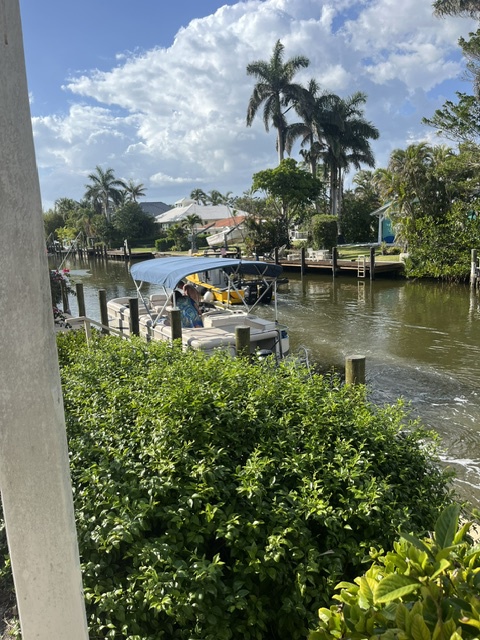 The property offers direct canal access to Florida's pristine waterways, surrounded by lush tropical landscaping and swaying palms—a perfect retreat for boating enthusiasts and nature lovers.