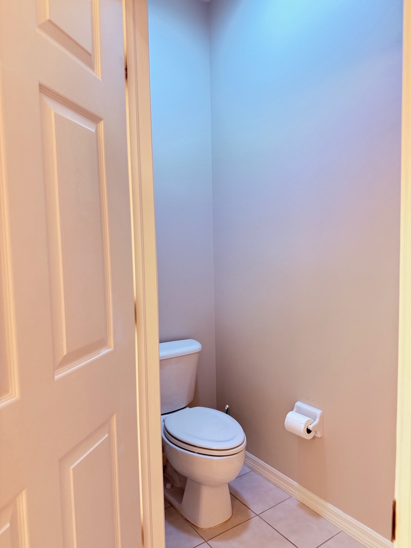 Step into a pristine, well-appointed bathroom designed for your comfort. Crisp white finishes and classic tilework create a fresh, welcoming space where you can unwind.