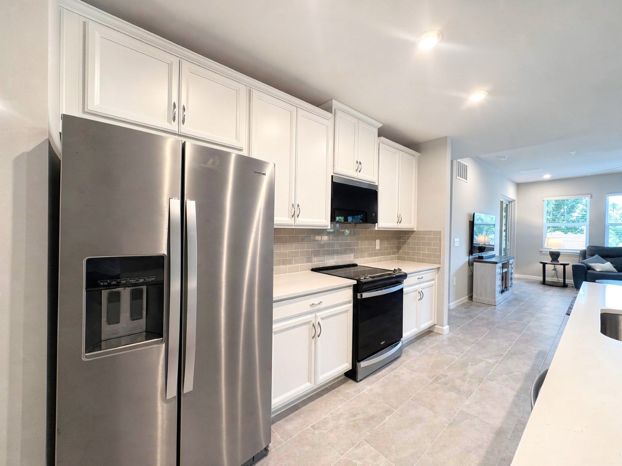 Cook your favorite meals in this bright, fully-equipped kitchen, complete with stainless steel appliances and plenty of counter space. The open layout flows seamlessly into the living area, perfect for staying connected while you prepare.