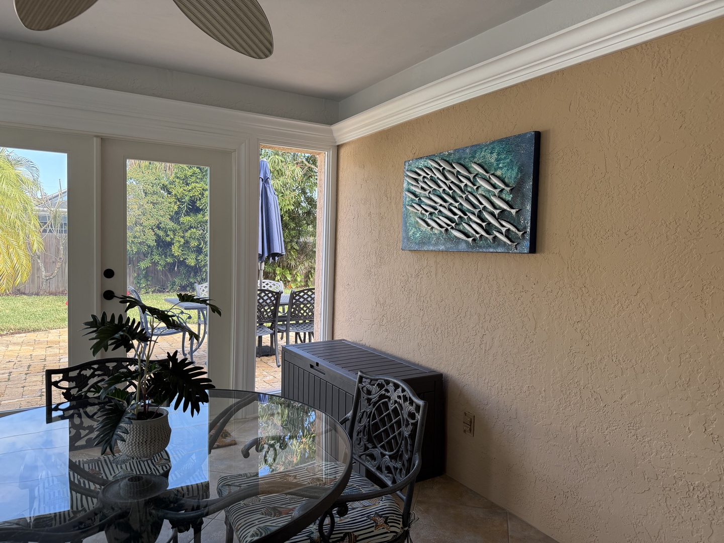 Relax in your bright Florida Sunroom area with tropical garden views through French doors leading to your private patio.