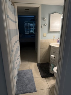 Your private bathroom features a clean vanity, fresh towels, and a convenient layout—perfect for refreshing after a day of exploring.