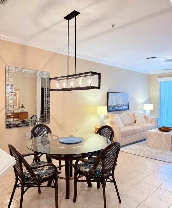 Unwind in your airy open-concept living and dining space, where coastal artwork and soft lighting create a tranquil atmosphere perfect for relaxing after a day of adventure.