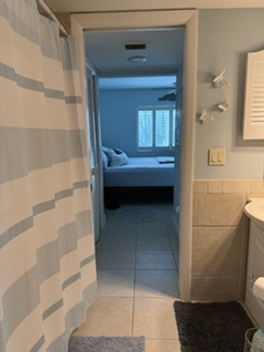Step out of your refreshing shower and enjoy a seamless flow into the peaceful bedroom just beyond. The soft linens and calming tones invite you to unwind after a long day of exploring.
