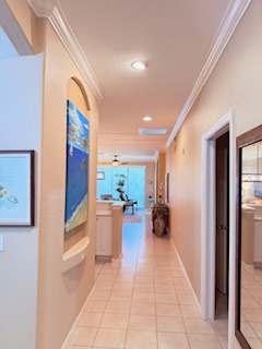 Step inside and find yourself in a bright, welcoming hallway that connects your vacation retreat. Warm lighting and coastal artwork guide you through this serene passage to your home away from home.