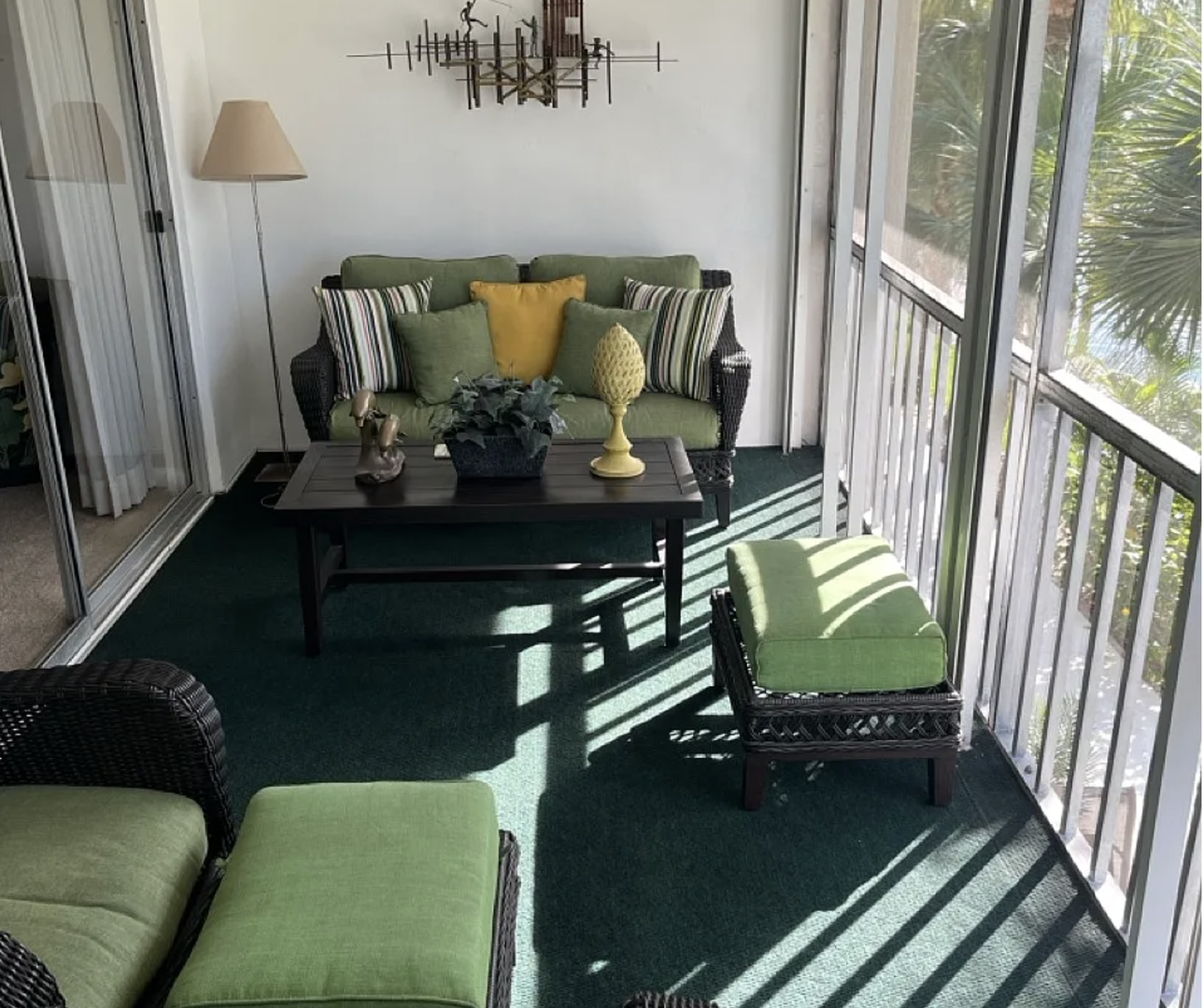 Your private screened lanai overlooks lush tropical palms, offering a peaceful spot to relax with morning coffee or unwind with a good book in the Florida sunshine.