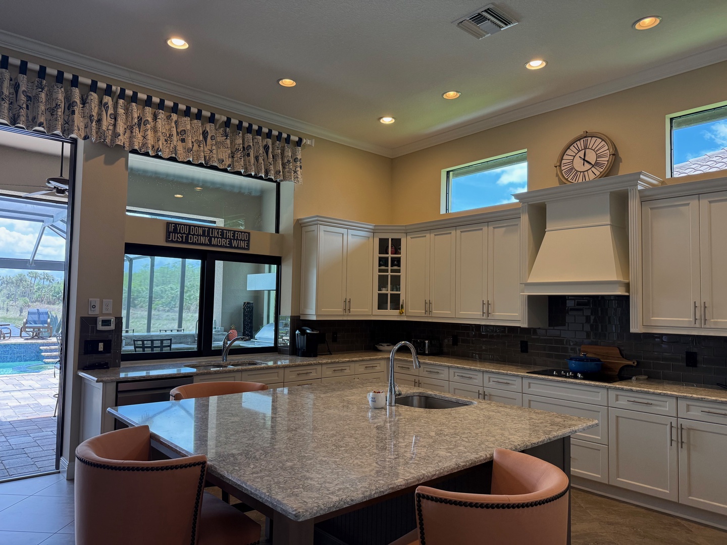 Step into your gourmet kitchen where granite countertops and premium appliances await your culinary adventures, with stunning pool views.
