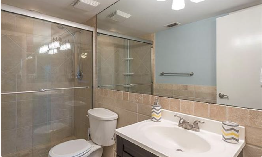 Freshen up in your pristinely tiled bathroom with a spacious walk-in shower, polished vanity, and thoughtful touches that make each morning feel effortless.