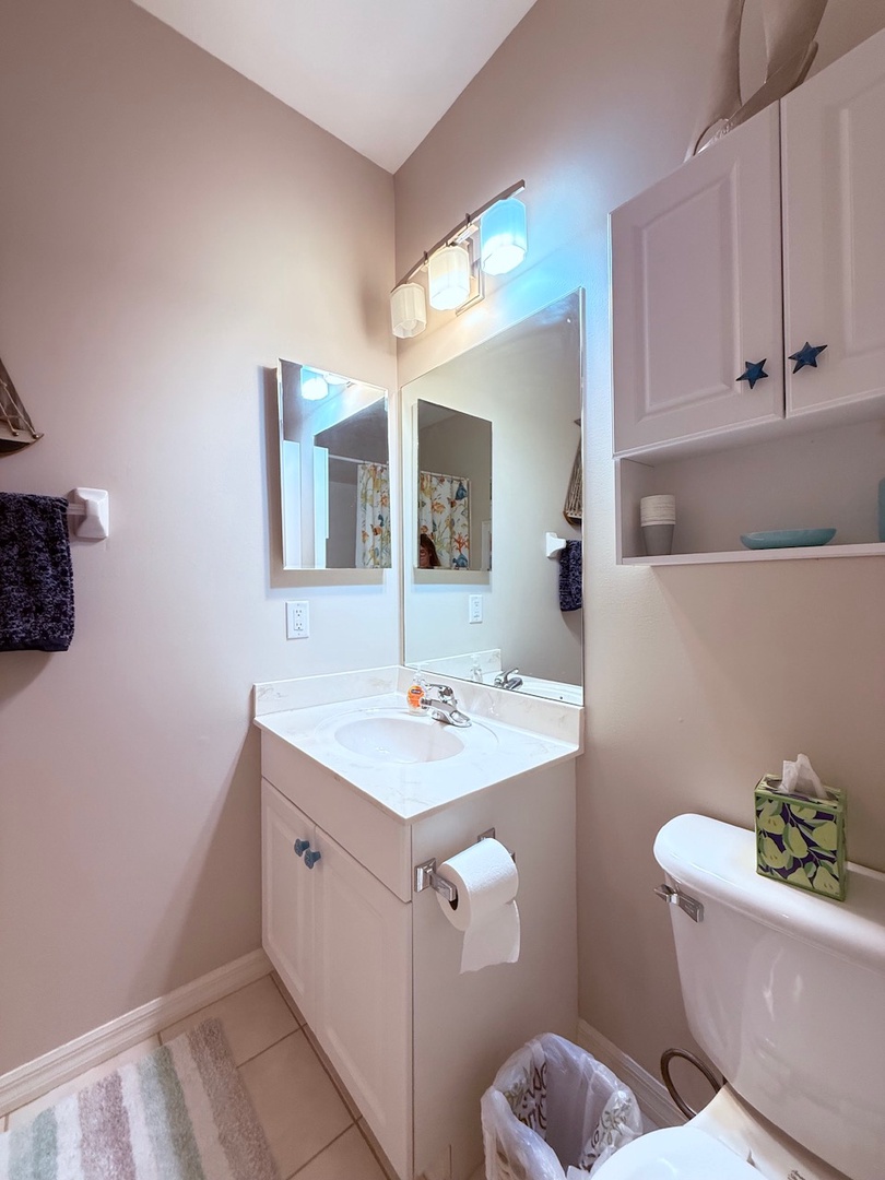 Your private bathroom offers a bright, modern space with a full vanity, mirror, and shower—everything you need to refresh and recharge during your stay.