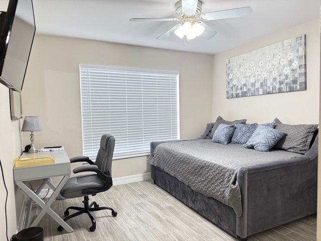 Rmote Workspace Unwind in your cozy bedroom featuring a plush bed, dedicated workspace, and soothing neutral tones for restful nights.