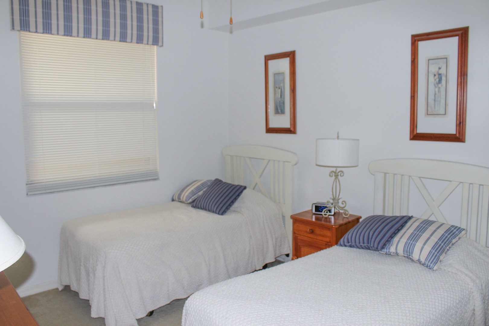 Your peaceful twin bedroom offers comfortable beds with crisp linens and coastal blue accents for restful nights.