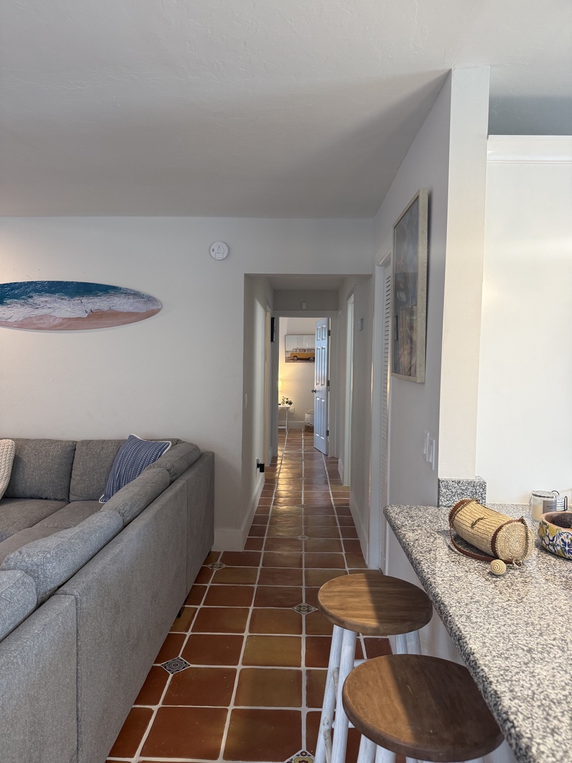 Your fully equipped kitchen features warm terracotta tile backsplash, modern appliances, and granite countertops—perfect for preparing meals during your stay.