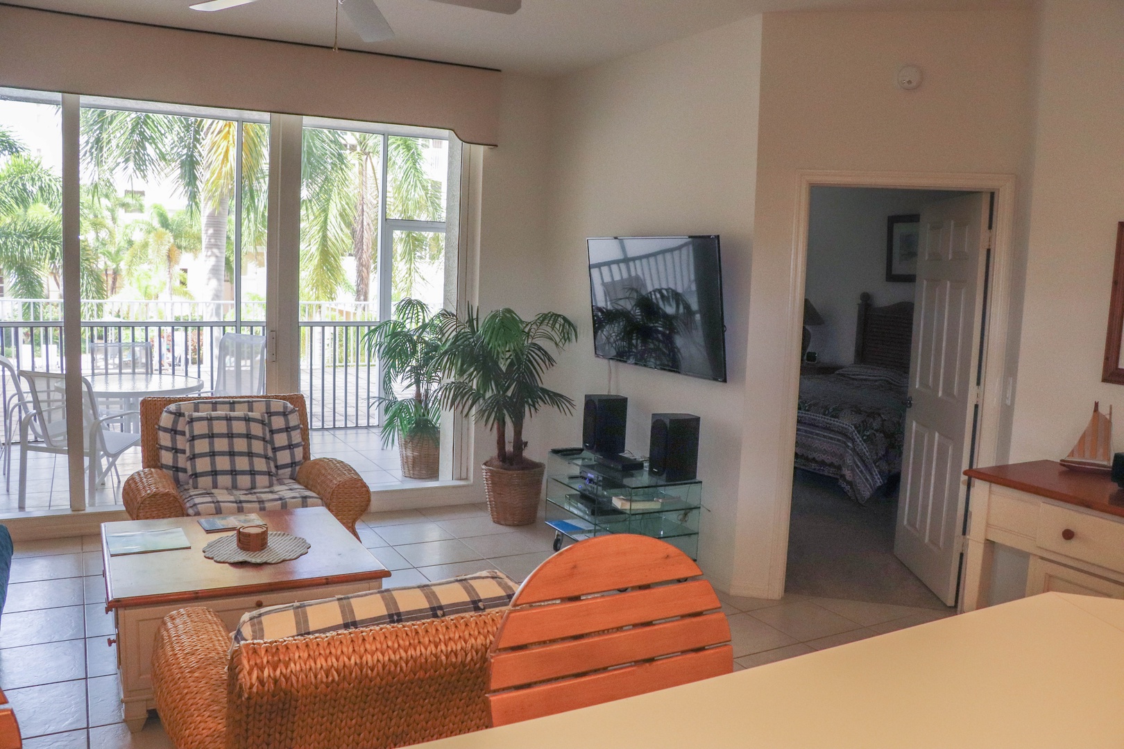 Relax in your bright living space with tropical views through sliding doors to your private balcony.