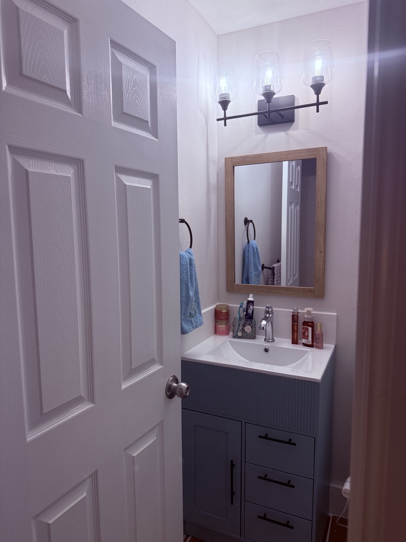 Your stylish bathroom features a crisp vanity with modern fixtures, thoughtful shelving for your toiletries, and soft lighting to help you feel right at home.