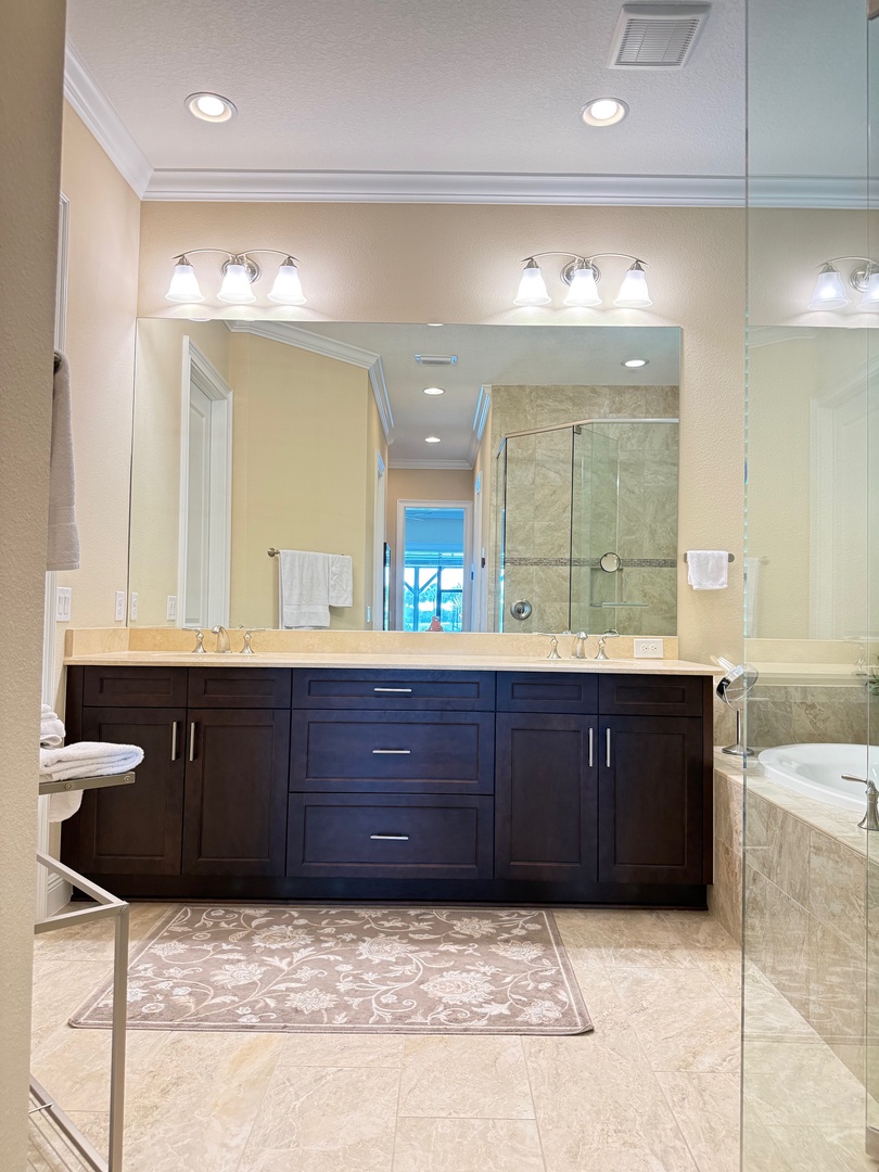 Step into your luxurious bathroom retreat with elegant stone tiles, walk-in shower, and vanity lighting for perfect morning routines.