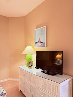 Unwind in your serene bedroom, where warm peach tones and thoughtful decor create your perfect retreat.