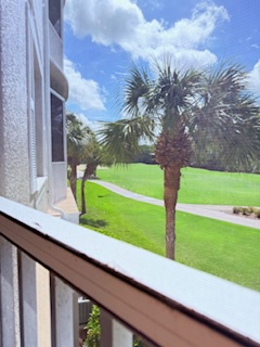 Your private balcony overlooks lush green lawns and swaying palms, offering a peaceful spot to sip morning coffee or unwind after exploring the area.