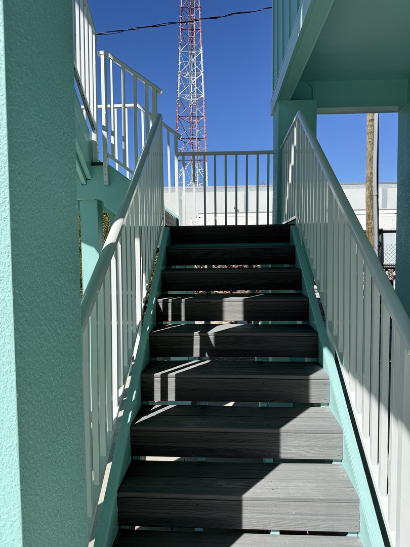 Modern terrace with striking geometric design features clean lines and contemporary architecture under bright blue skies.