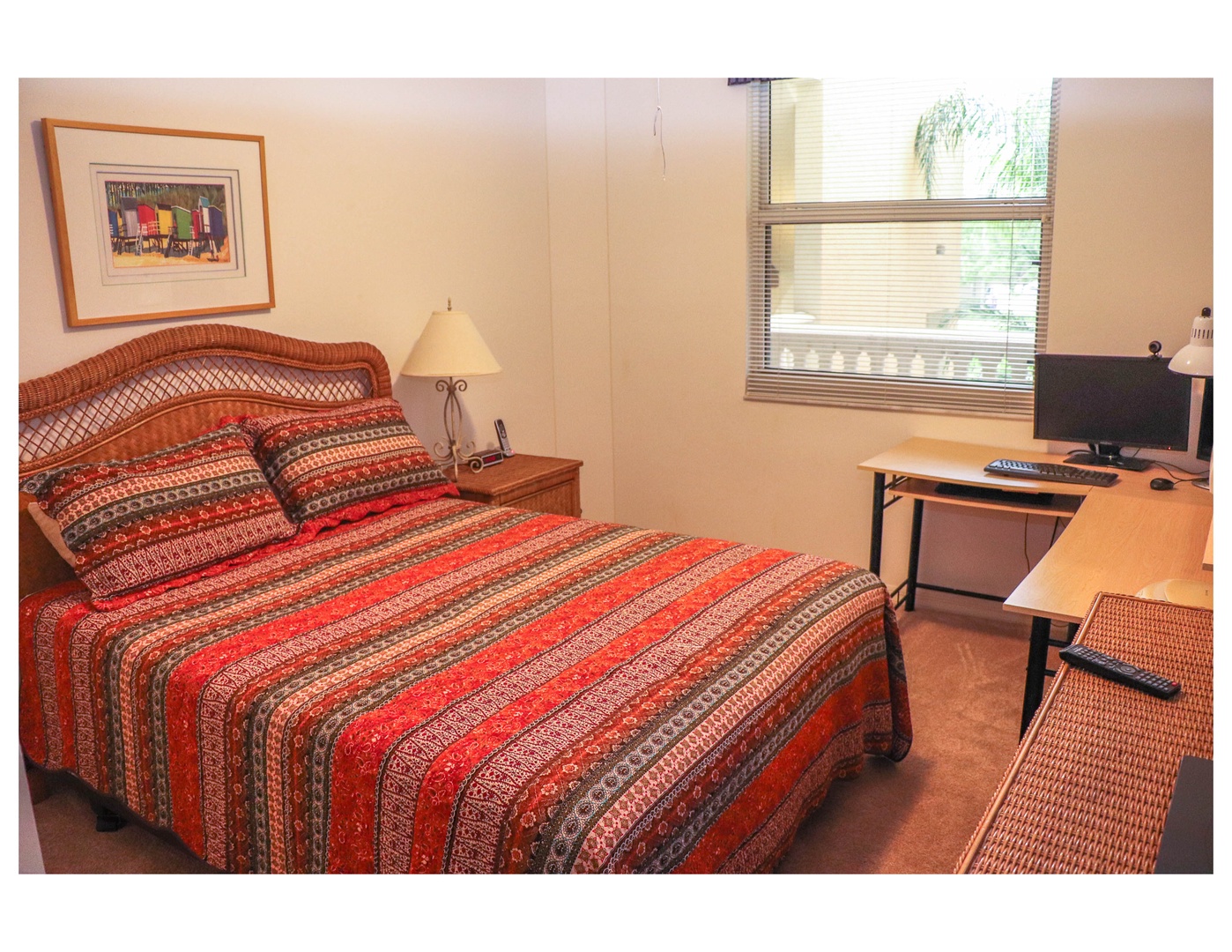 Your cozy bedroom features warm earth tones, comfortable bedding, and a dedicated workspace by the window where natural light streams in.
