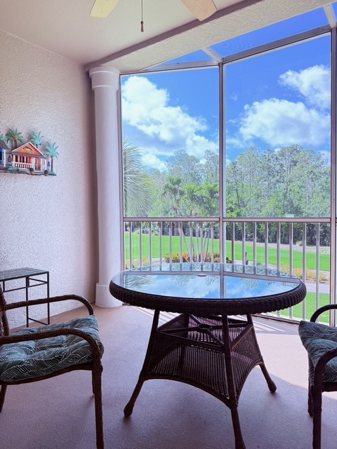 Relax on your private screened balcony with views of the lush green lawn and tropical palms—your perfect spot for morning coffee or afternoon unwinding.