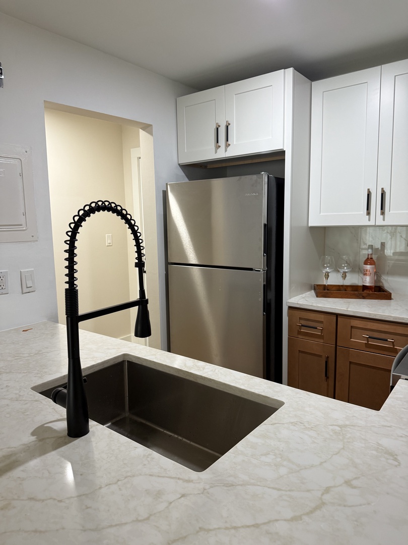 Your sleek kitchen features modern appliances and marble countertops, perfect for preparing meals during your stay.