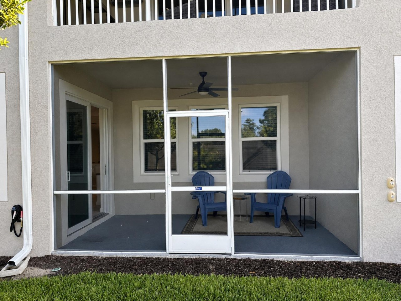 Your screened-in patio offers a breezy, bug-free retreat with Adirondack chairs and a ceiling fan—perfect for morning coffee or evening relaxation outdoors.
