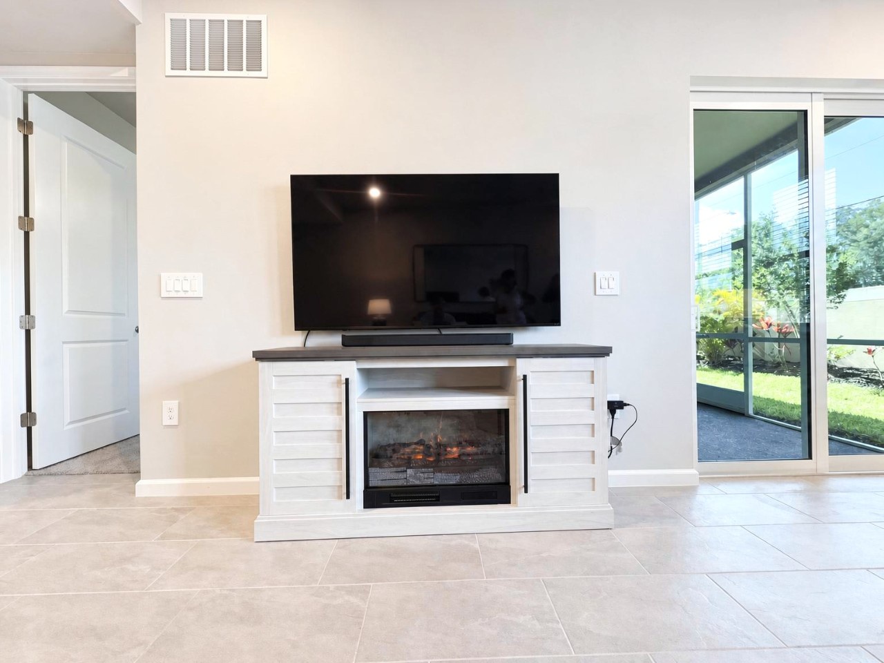Unwind in your bright, airy living space where a cozy fireplace creates warmth and ambiance while large sliding doors open to your private outdoor retreat.