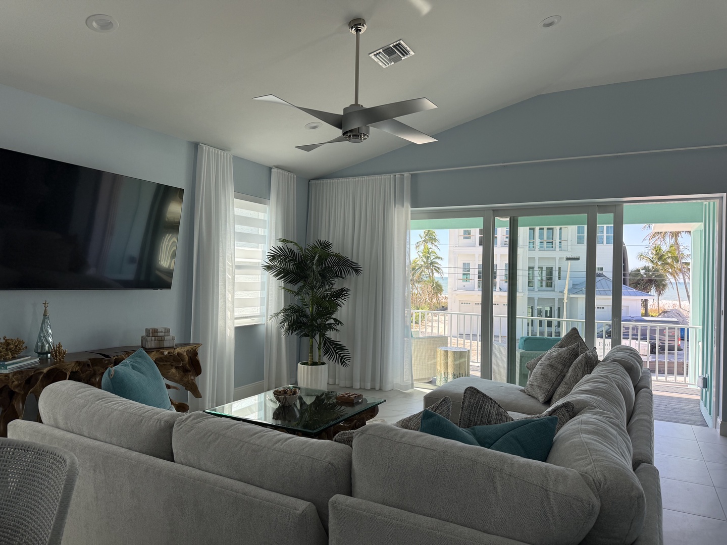 Relax in your stylish living space with plush seating, modern amenities, and refreshing coastal breezes from your private balcony.