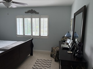 Step into your peaceful bedroom retreat, where soft light filters through plantation shutters and a plush area rug welcomes your feet each morning.