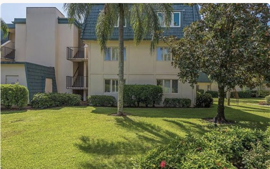 Your vacation rental sits in a peaceful tropical setting, surrounded by lush lawns, swaying palms, and mature trees that offer shade and privacy.
