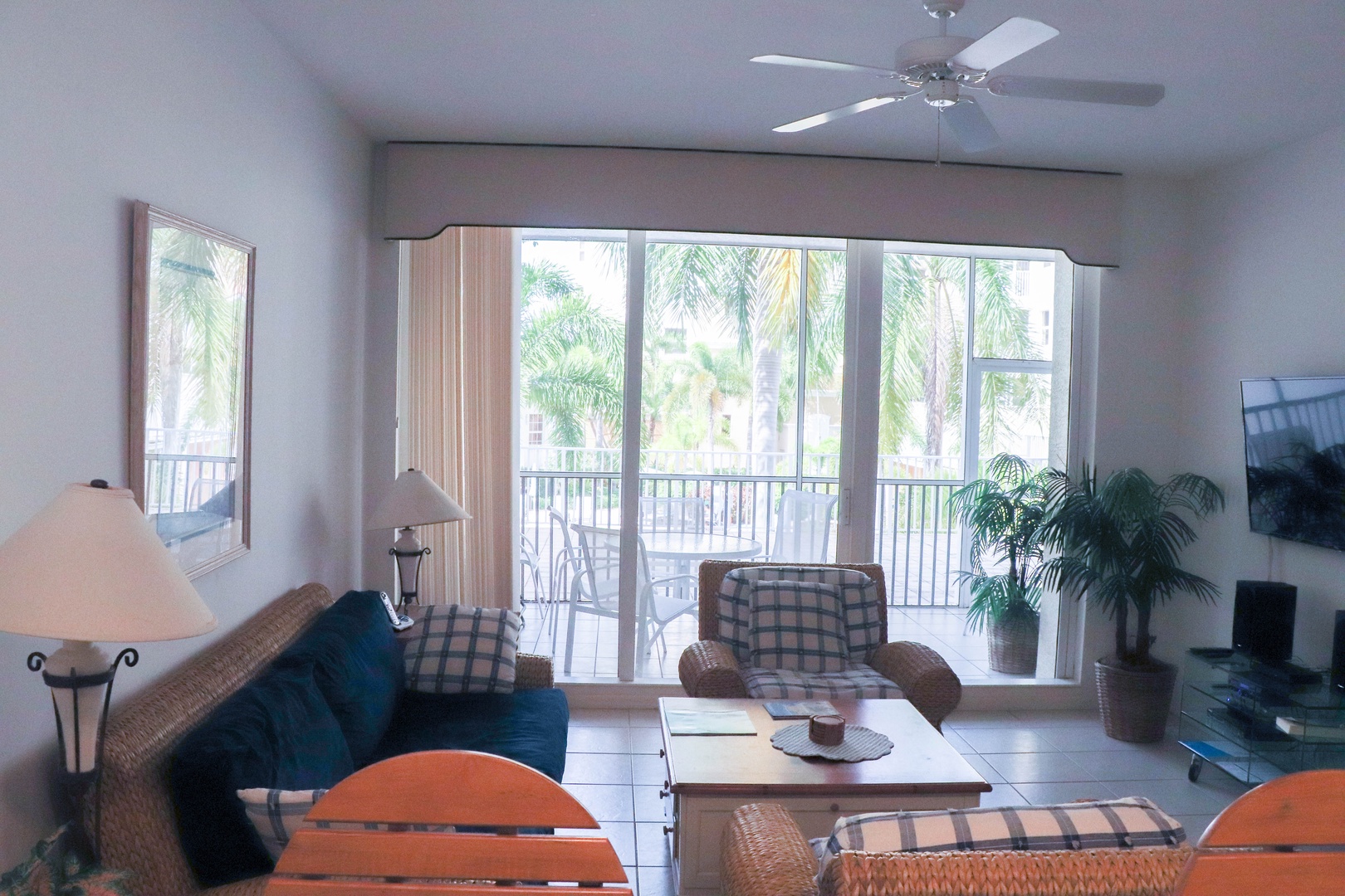 Relax in your bright living space with comfy seating and tropical palm views from your private balcony.
