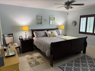 Step into your peaceful retreat. This spacious bedroom features a plush king bed, soft lighting, and calming coastal tones. Wake refreshed by the gentle hum of the ceiling fan above you.