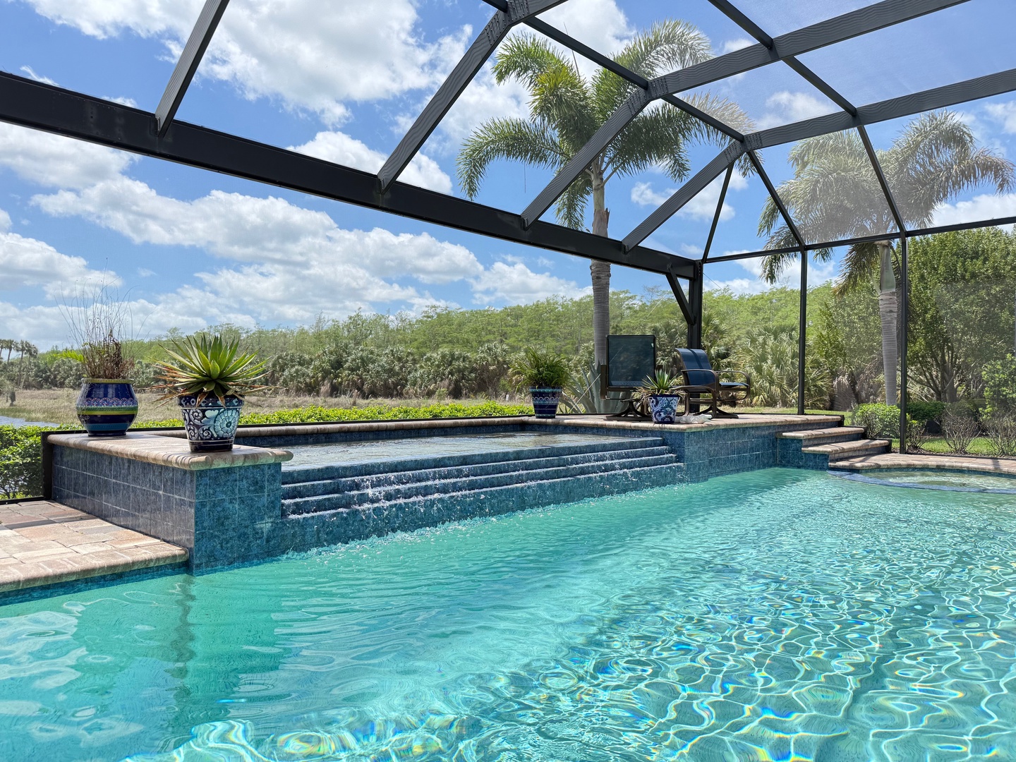 Dive into your private oasis with this stunning screened pool, where crystal-clear waters and tropical views create the perfect escape.