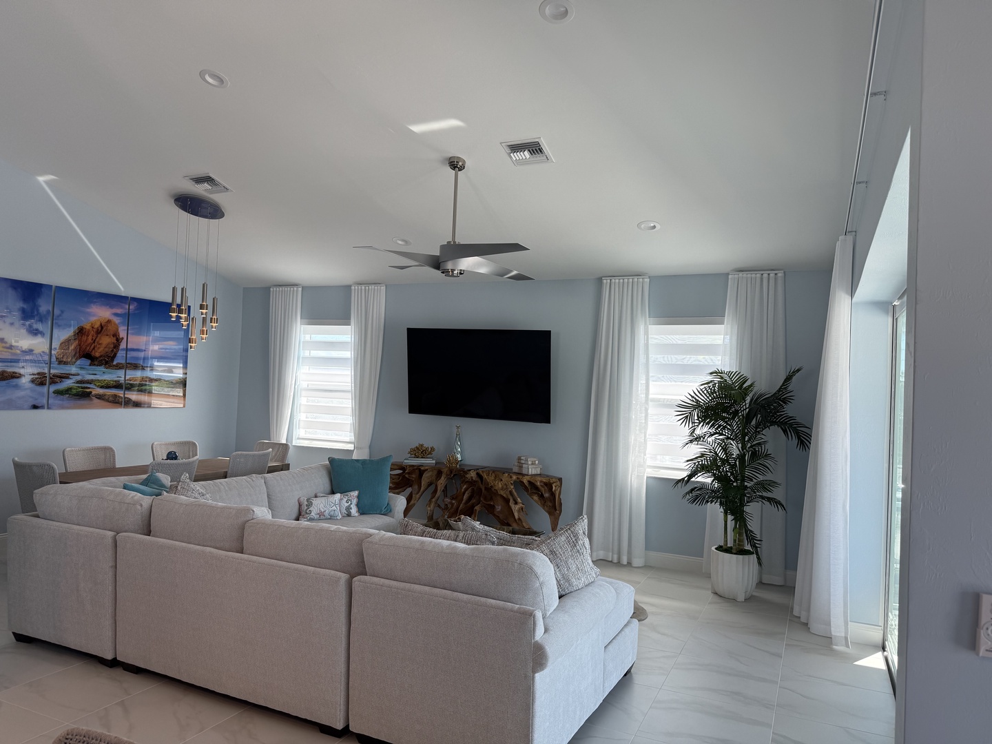 Sink into the plush sectional and enjoy your favorite shows on the large flat-screen TV in this bright, airy living space.