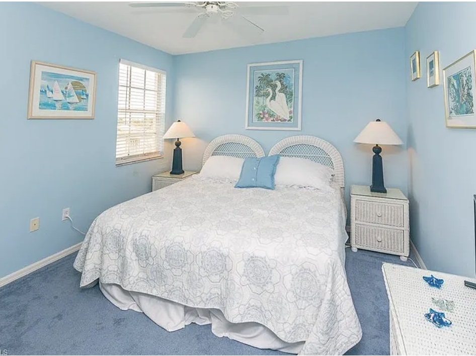 Drift off in your serene coastal bedroom, where soft blue walls and coastal artwork create a peaceful retreat after a day exploring the shore.