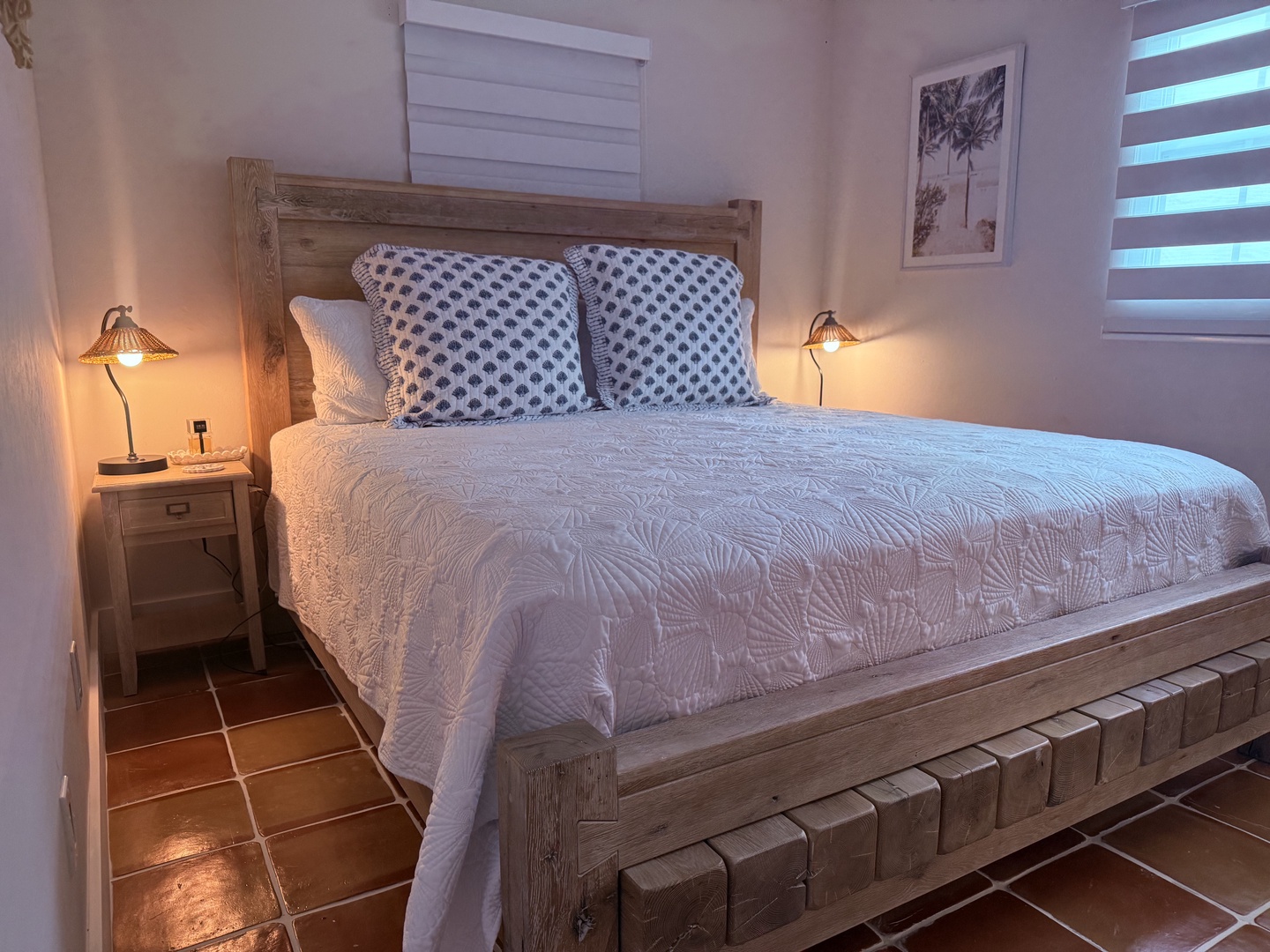 Sink into crisp linens and coastal charm in your thoughtfully designed bedroom. Warm bedside lighting and natural textures create a peaceful retreat where you'll drift off to the gentle rhythms of island life.