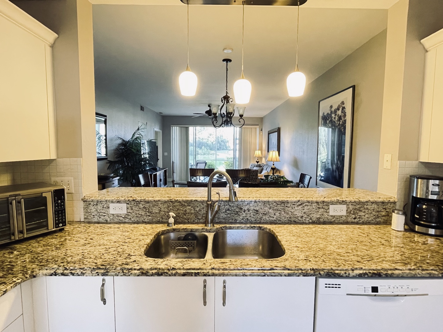 Your gourmet kitchen opens to a bright living space with granite counters and modern appliances for memorable meals together.