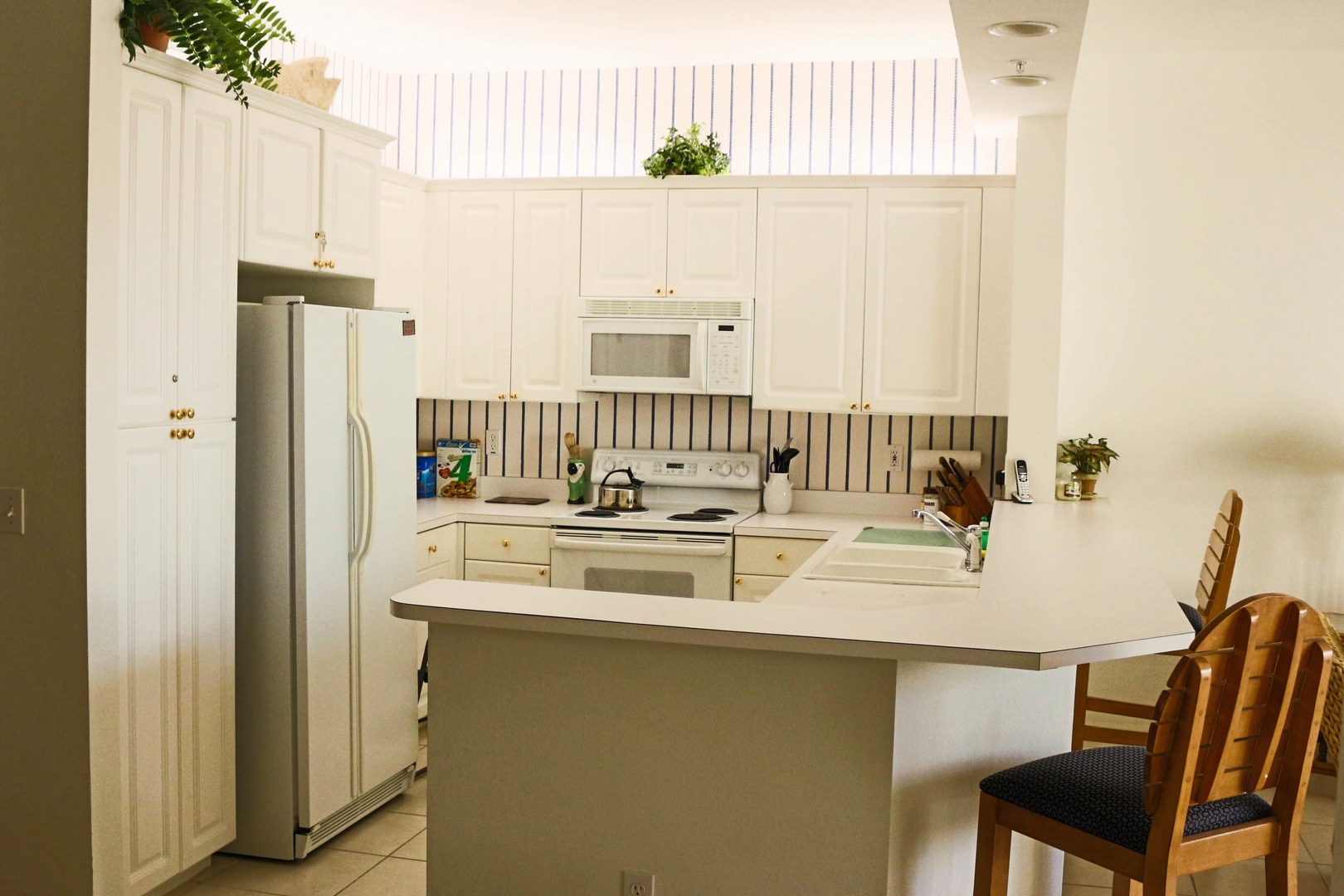 Your fully equipped kitchen awaits with modern appliances and breakfast bar seating for easy meal prep and casual dining.