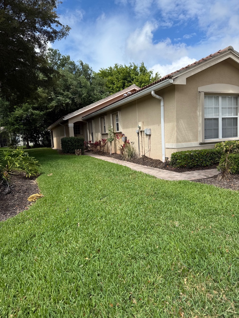 Spacious property featuring landscaped grounds with mature trees and well-maintained lawn areas.