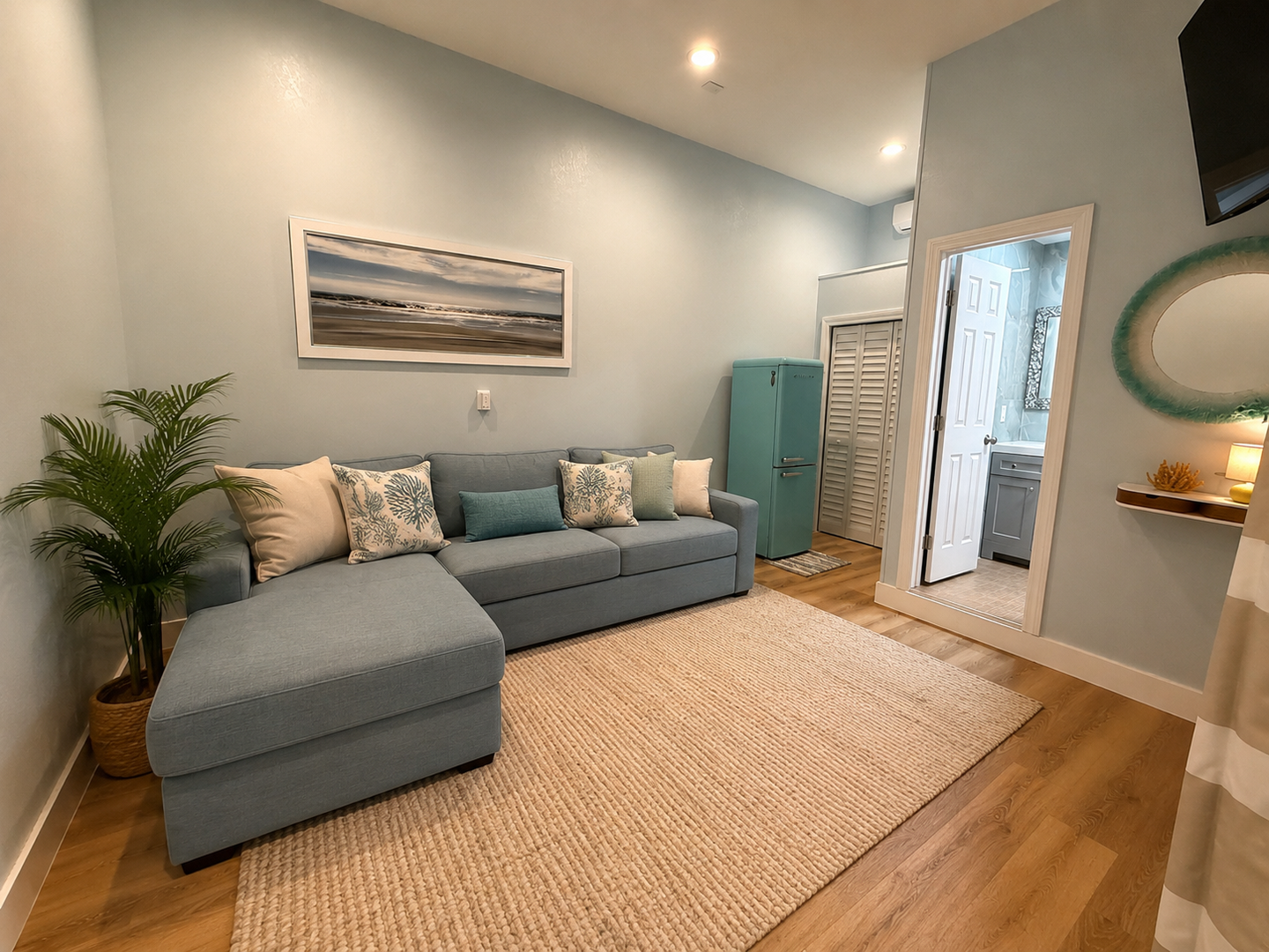 Sink into your plush sectional after a day of exploring—folds out to a queen sleeper. Soft coastal blues, warm wood floors, and stylish touches create the perfect retreat for unwinding in comfort.