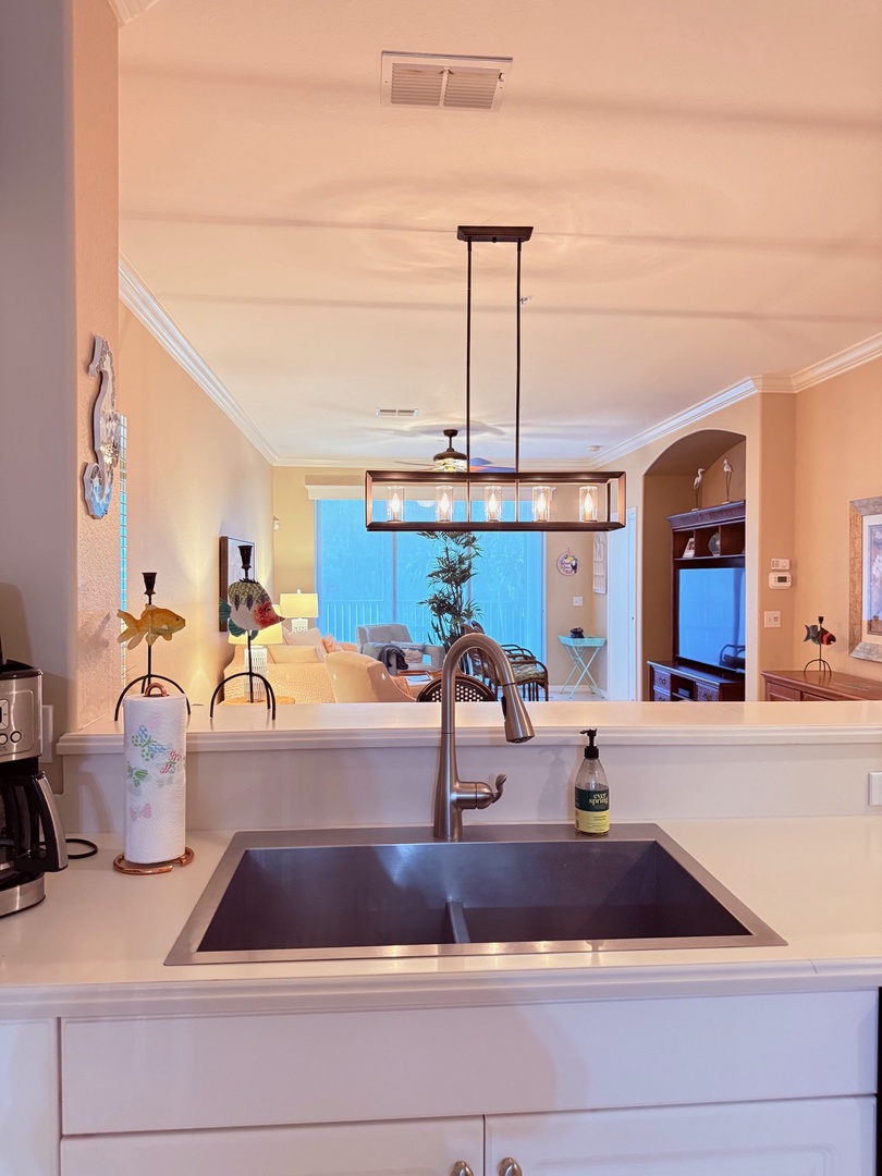 Bright kitchen with modern appliances and open views—perfect for preparing your morning coffee while enjoying natural light streaming through the windows.