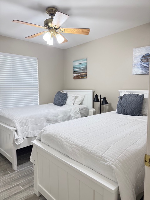 Third bedroom Two twin beds Rest peacefully in your cozy twin bedroom with coastal decor and gentle ceiling fan creating the perfect retreat.