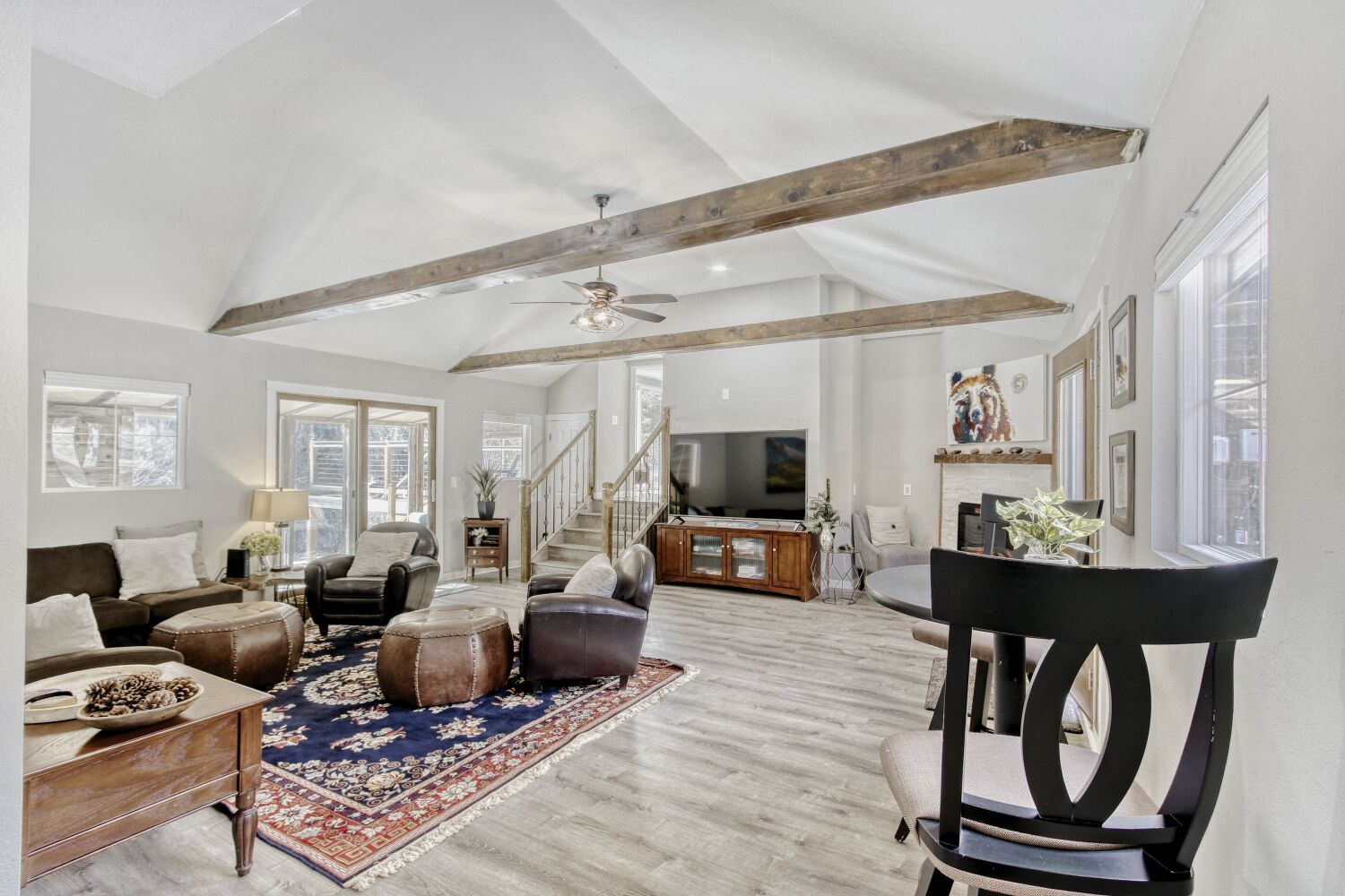 Relax in the spacious living room with soaring ceilings, rustic beams, and cozy fireplace—perfect for unwinding after exploring.