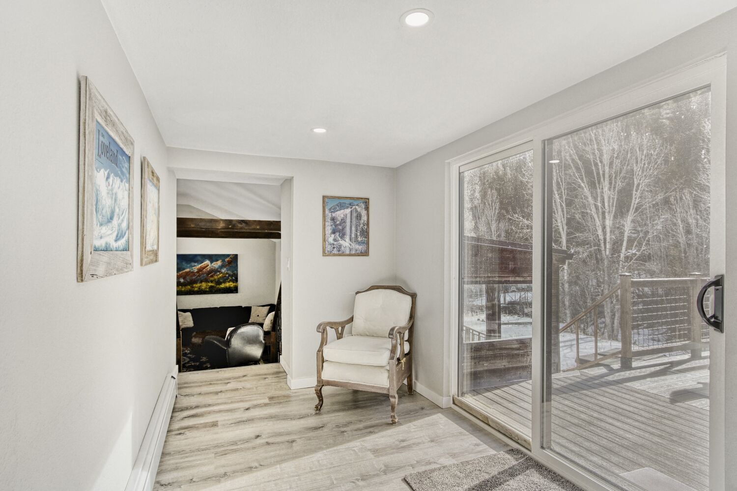 The hallway between the living room and Kitchen leads to the deck where you can enjoy some peaceful outdoor time!