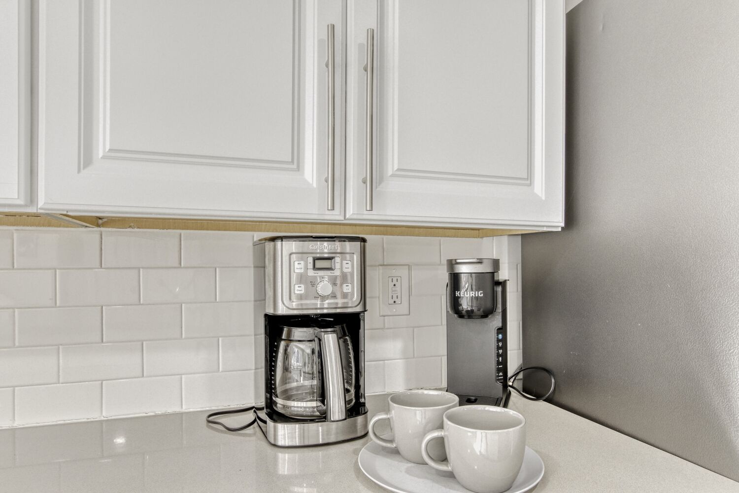 Start your mornings right with premium coffee equipment and fresh mugs waiting for your perfect brew in your sleek kitchen.